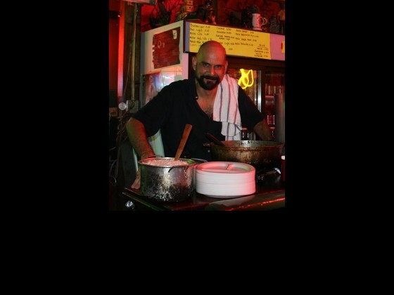 Martin Krusche cooking curry at Saturn Bar. Photo courtesy of Martin.