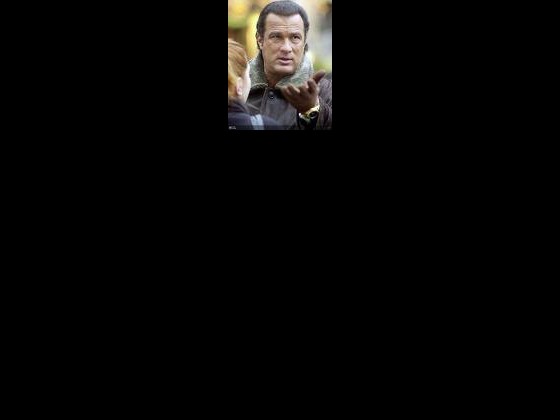Seagal with an up turned open hand in front of a person