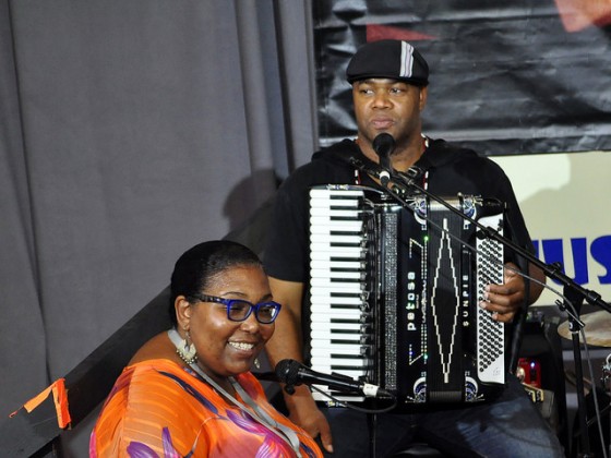 WWOZ's Maryse Dejean and Bruce 'Sunpie' Barnes on the Allison Miner Stage on Day 6 [Photo by Stafford]