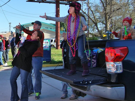 Family using pickup tailgate as balcony