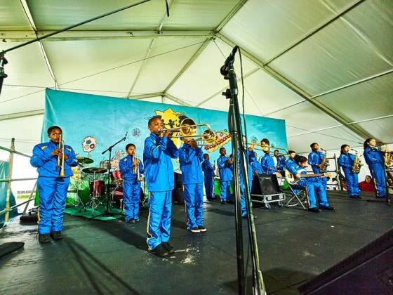 Young Audiences Brass Band performs in the Kids Tent at Jazz Fest 2016 [Photo by Eli Mergel]