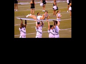 UH Cheerleader on surfboard