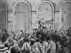 image of mob using a battering ram to break the parish prison's doors