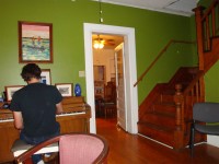 Quintron practicing on piano inside the Guest House before show