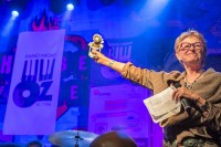 Deborah Harkins of WWOZ's Board of Directors with the evening's award for Henry Butler at Piano Night 2015 [Photo by Marc PoKempner]