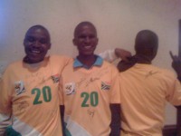 Three guys with South African soccer jerseys all with Hugh Masekela's signature