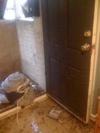 Water debris outside the door are above the door knob